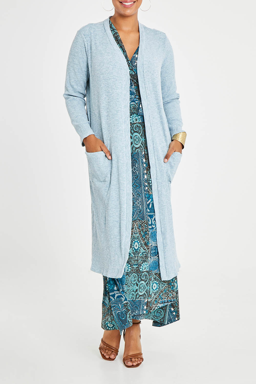 Model Noli wearing size 14 of the Sunset Watching Cardi in colour Sky (Blue), from the front, cropped image