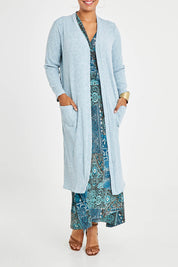 Model Noli wearing size 14 of the Sunset Watching Cardi in colour Sky (Blue), from the front, cropped image