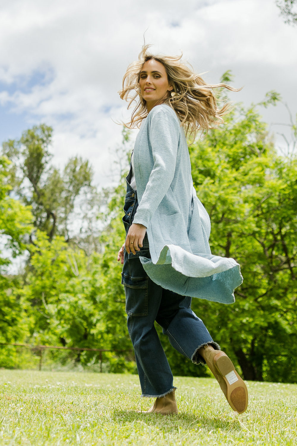 Model Tegan wearing size 10 of the Sunset Watching Cardi in colour Sky (Blue), from the front, showing the whole outfit