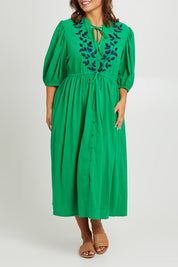 Model Monique wearing size 14 of the For Love And Dancing Dress in colour Emerald (Green), from the front, cropped image