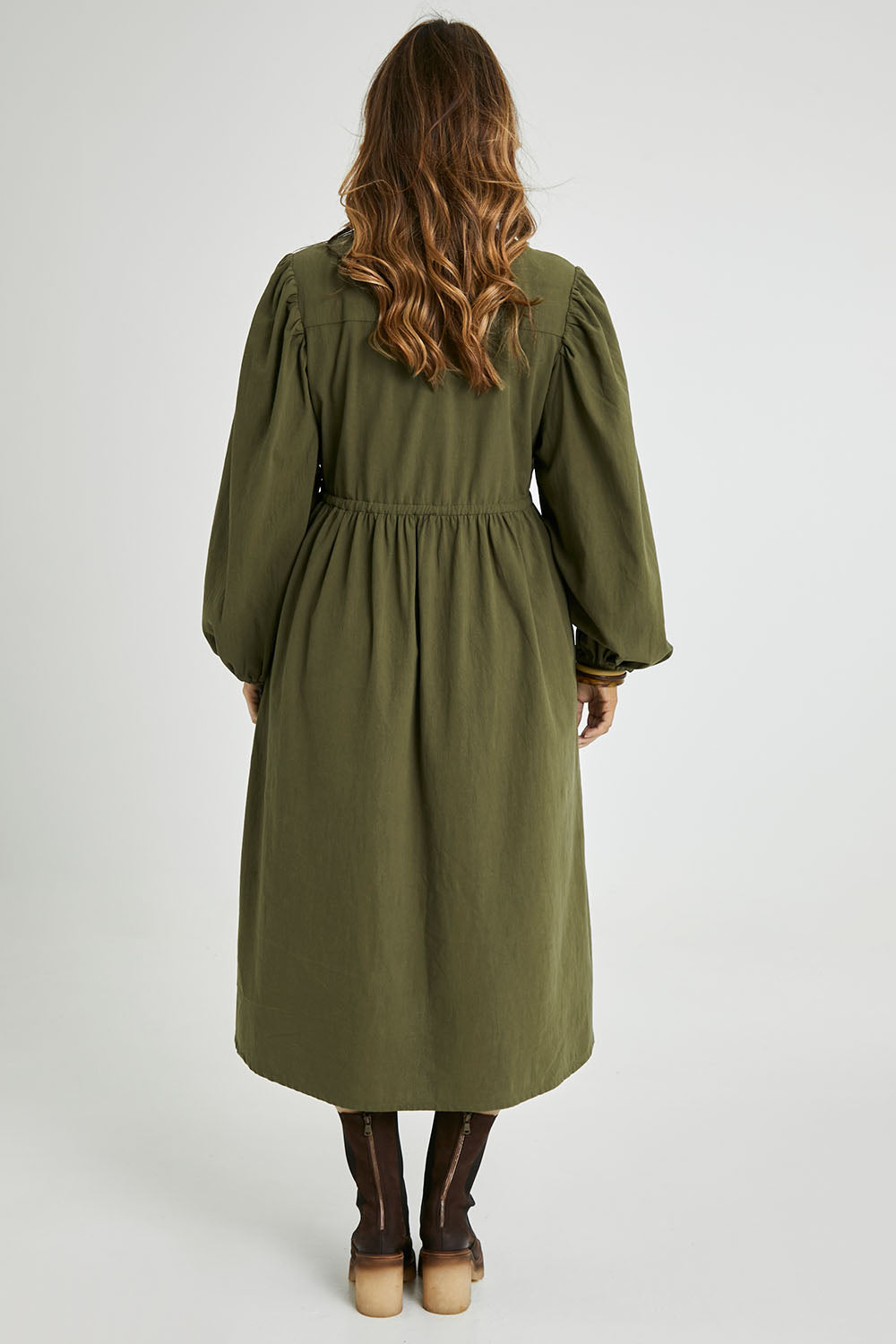 Model Laura wearing size 14 of the For Love And Dancing Dress in colour Khaki (Green), from the back