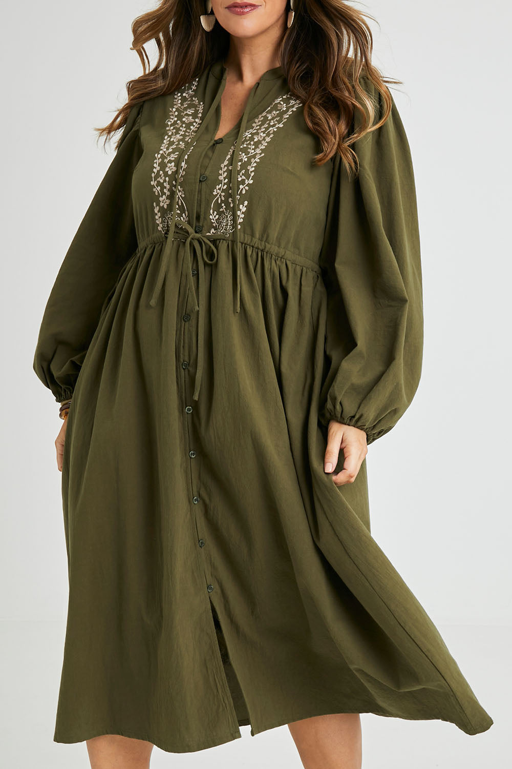 Model Laura wearing size 14 of the For Love And Dancing Dress in colour Khaki (Green), from the front, cropped image