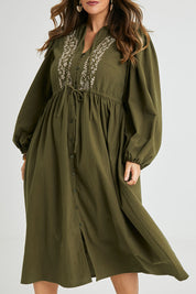 Model Laura wearing size 14 of the For Love And Dancing Dress in colour Khaki (Green), from the front, cropped image