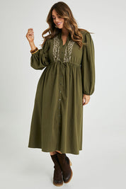 Model Laura wearing size 14 of the For Love And Dancing Dress in colour Khaki (Green), from the front, showing the whole outfit