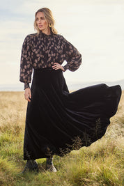 Model Tegan wearing size 10 of the Love By Candlelight Velvet Skirt in colour Black (Black), from the front, showing the whole outfit
