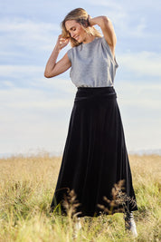 Model Tegan wearing size 10 of the Love By Candlelight Velvet Skirt in colour Black (Black), from the front, showing the whole outfit