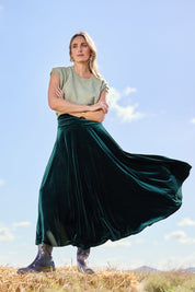 Model Tegan wearing size 10 of the Love By Candlelight Velvet Skirt in colour Ivy (Green), from the front, showing the whole outfit