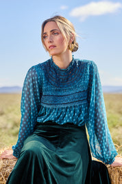 Model Tegan wearing size 10 of the Love By Candlelight Velvet Skirt in colour Ivy (Green), from the front, showing the whole outfit