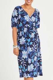 Model Noli wearing size 14 of the Can Go Everywhere Dress in colour Navyfleur (Blue), from the front, cropped image