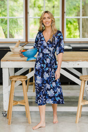 Model Tegan wearing size 10 of the Can Go Everywhere Dress in colour Navyfleur (Blue), from the front, showing the whole outfit