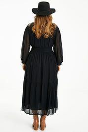Model Laura wearing size 14 of the Good Vibes Embroidered Dress in colour Black (Black), from the back