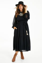 Model Laura wearing size 14 of the Good Vibes Embroidered Dress in colour Black (Black), from the front, showing the whole outfit