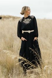 Model Tegan wearing size 10 of the Good Vibes Embroidered Dress in colour Black (Black), from the front, showing the whole outfit