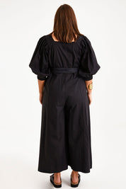 Model Monique wearing size 14 of the Big Love Cotton Jumpsuit in colour Black (Black), from the back