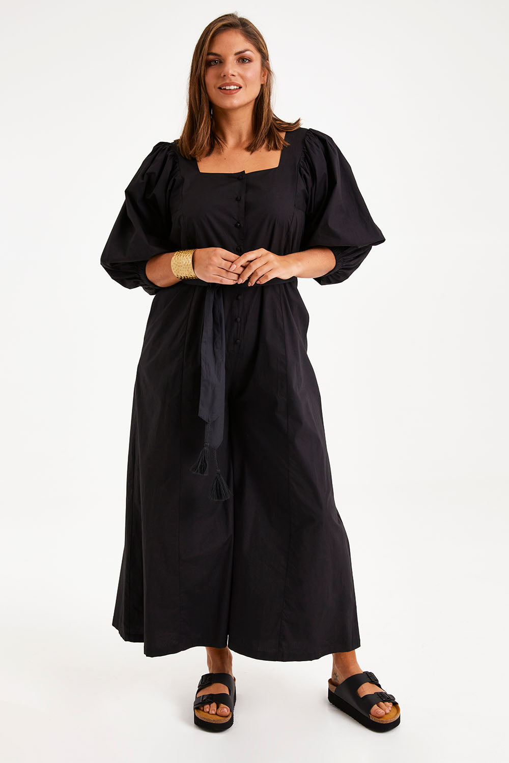 Model Monique wearing size 14 of the Big Love Cotton Jumpsuit in colour Black (Black), from the front, showing the whole outfit