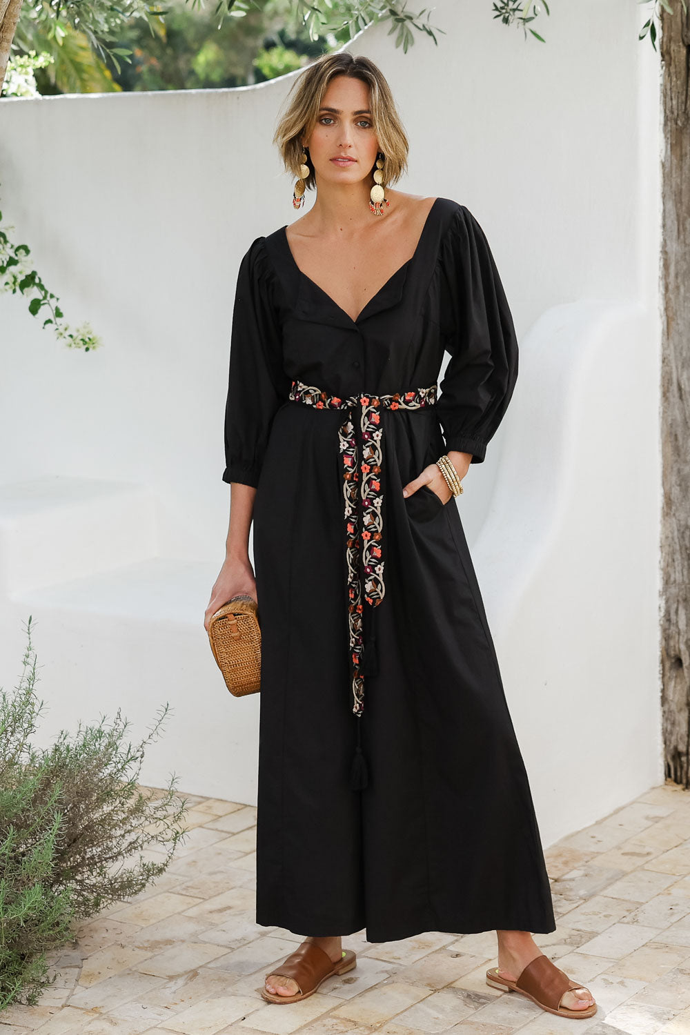 Model Tegan wearing size 10 of the Big Love Cotton Jumpsuit in colour Black (Black), from the front, showing the whole outfit