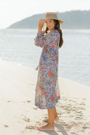 Model Alex wearing size 10 of the Now And Forever Dress in colour Icefleur (Blue), from the front, showing the whole outfit