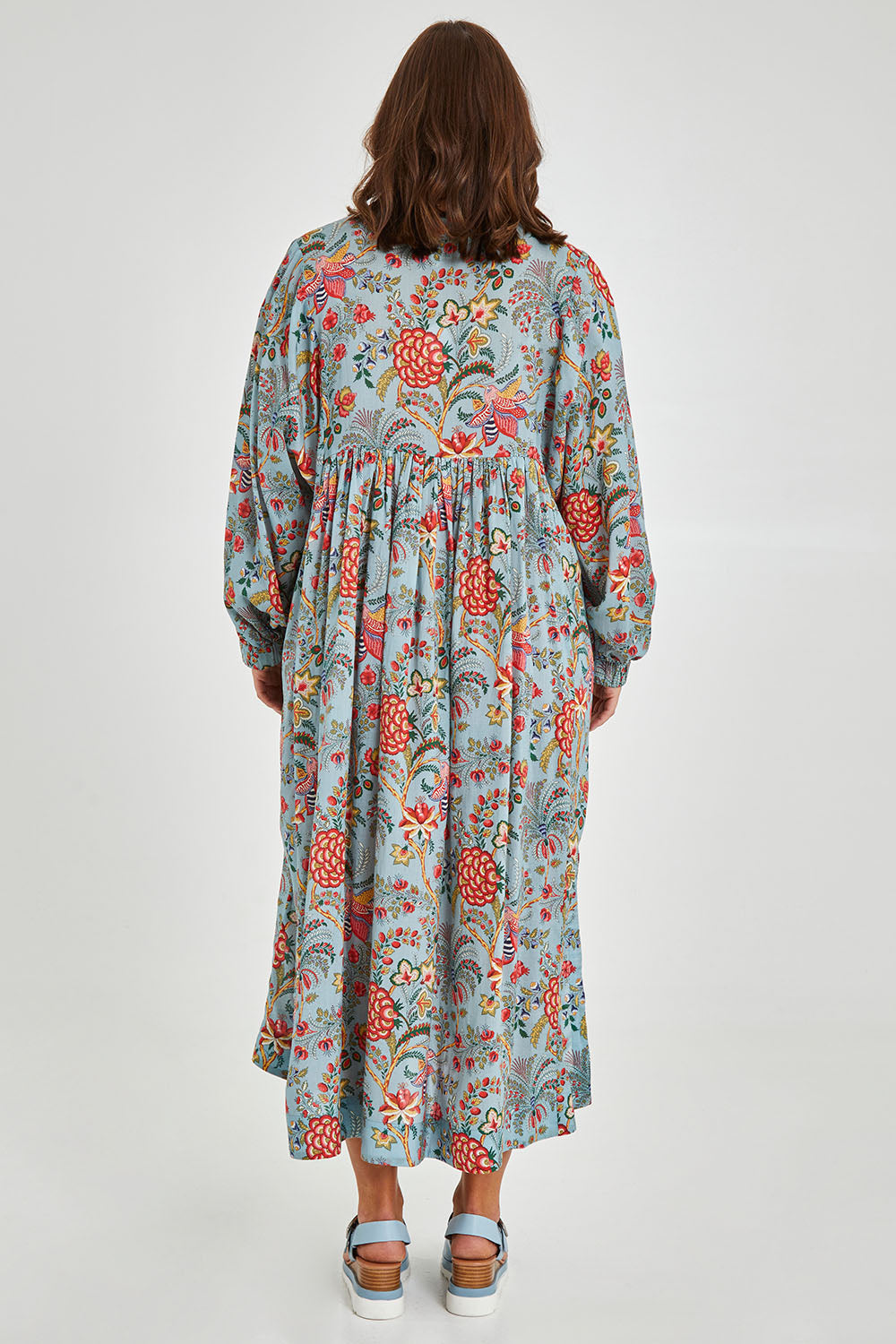 Model Monique wearing size 14 of the Now And Forever Dress in colour Icefleur (Blue), from the back