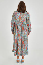 Model Monique wearing size 14 of the Now And Forever Dress in colour Icefleur (Blue), from the back