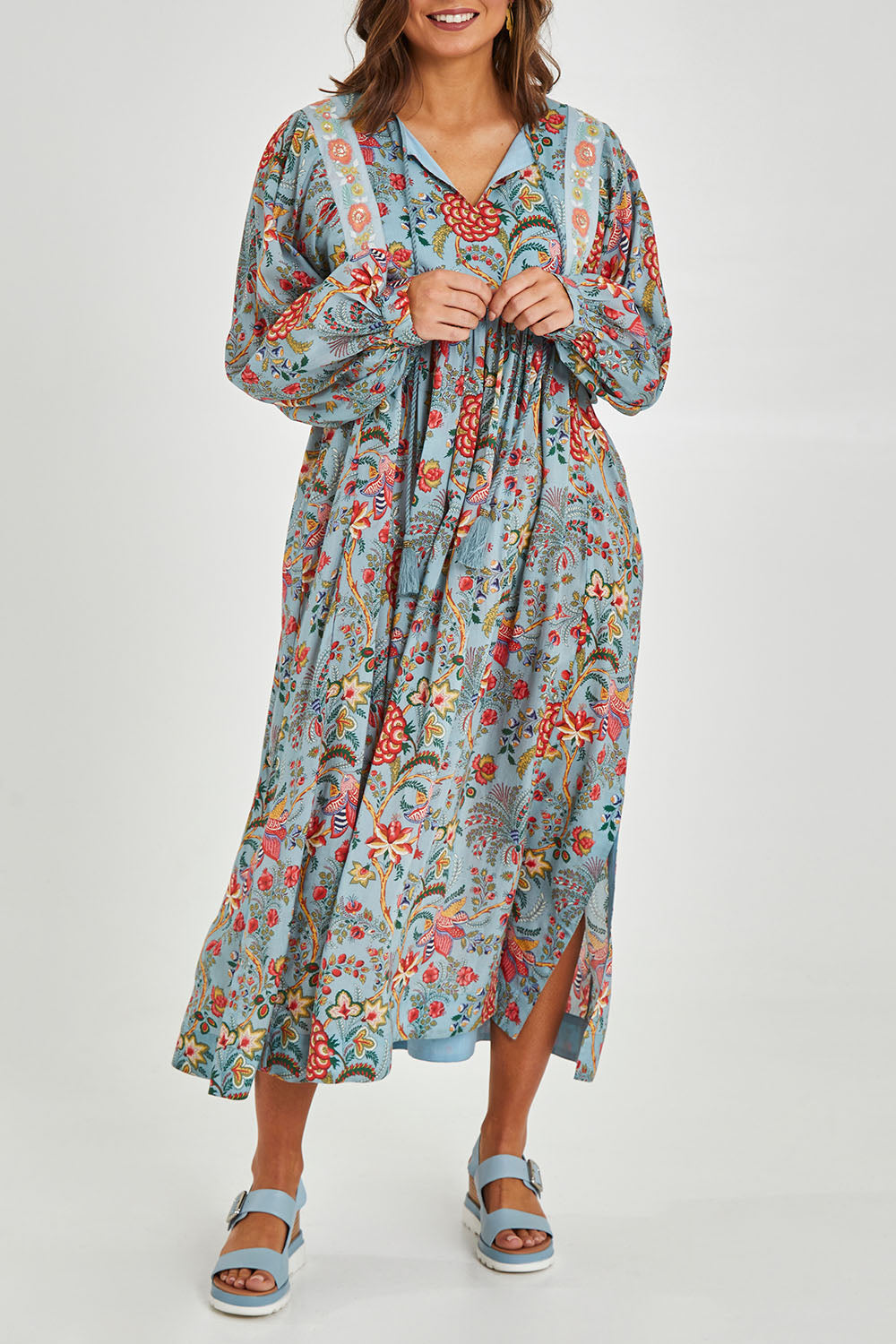 Model Monique wearing size 14 of the Now And Forever Dress in colour Icefleur (Blue), from the front, cropped image