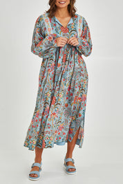 Model Monique wearing size 14 of the Now And Forever Dress in colour Icefleur (Blue), from the front, cropped image