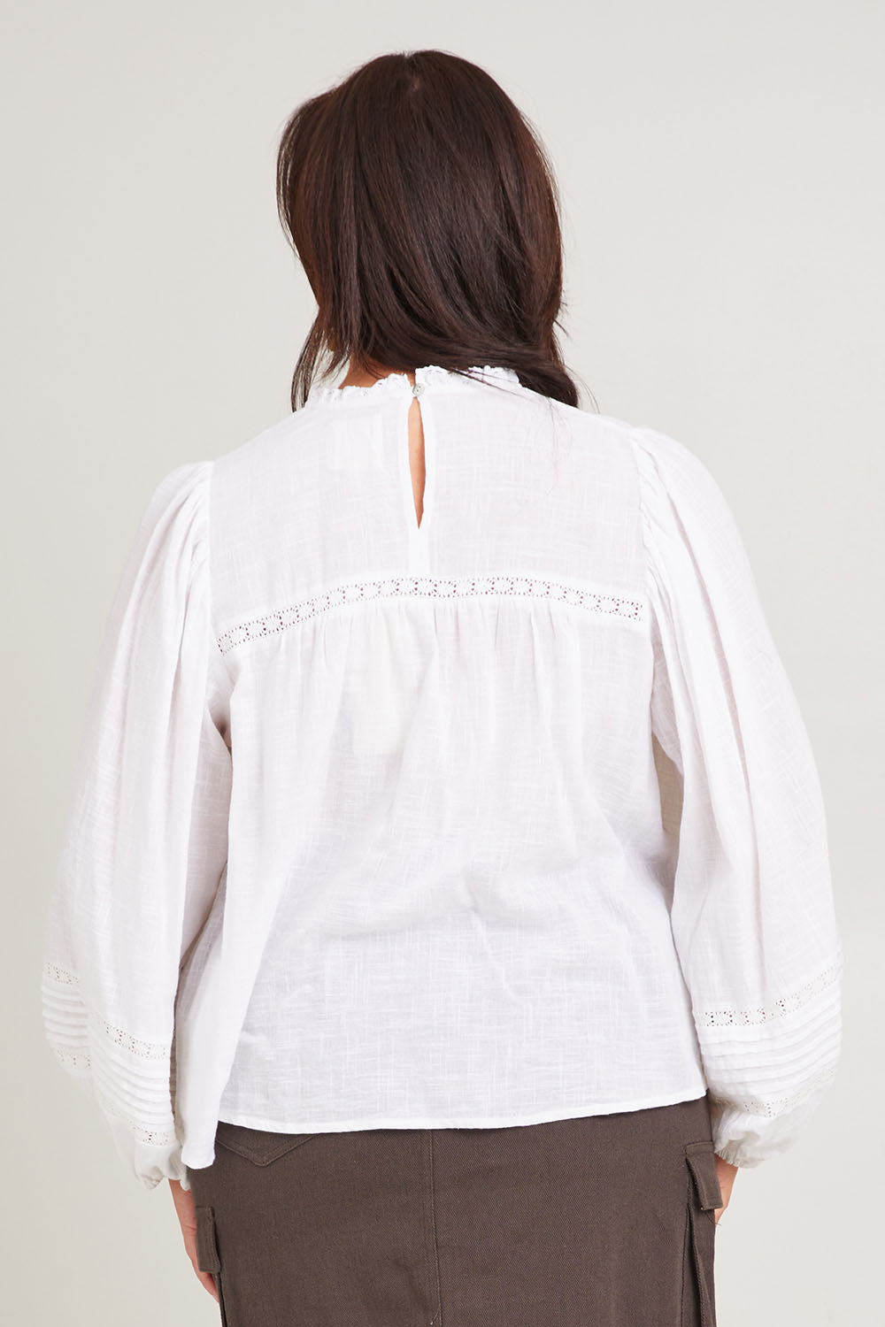 Model Poppy wearing size 16 of the My Fair Lady Blouse in colour White (White), from the back