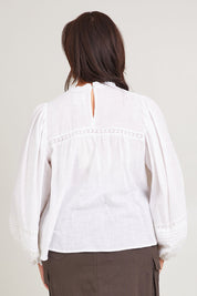 Model Poppy wearing size 16 of the My Fair Lady Blouse in colour White (White), from the back
