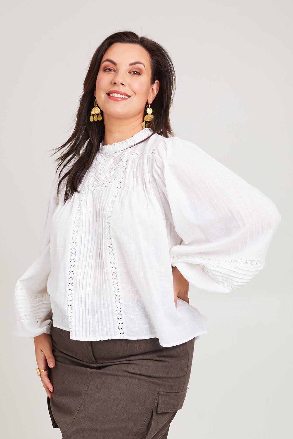 Model Poppy wearing size 16 of the My Fair Lady Blouse in colour White (White), from the front, cropped image