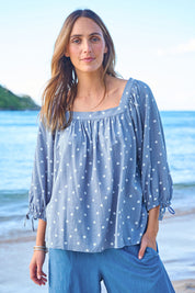 Model Tegan wearing size 10 of the Picking Flowers Blouse in colour Bluehue (Blue), from the front, showing the whole outfit