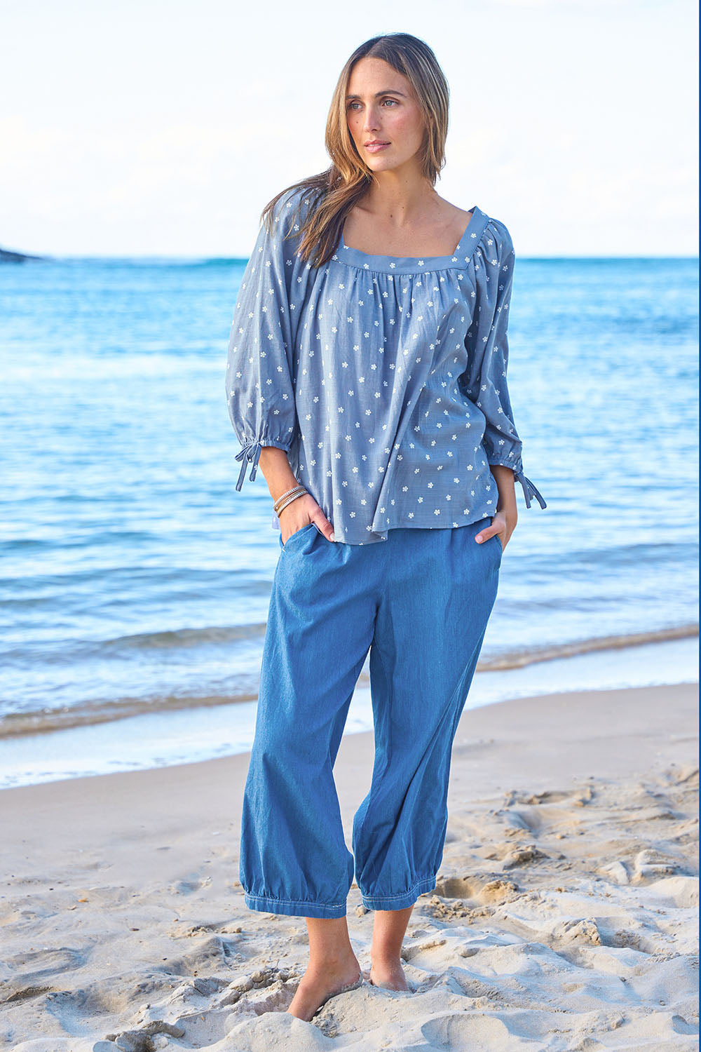 Model Tegan wearing size 10 of the Picking Flowers Blouse in colour Bluehue (Blue), from the front, showing the whole outfit