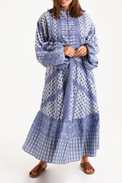 Model Monique wearing size 14 of the Under A Blue Sky Maxi Dress in colour Bluefleur (Blue), from the front, cropped image