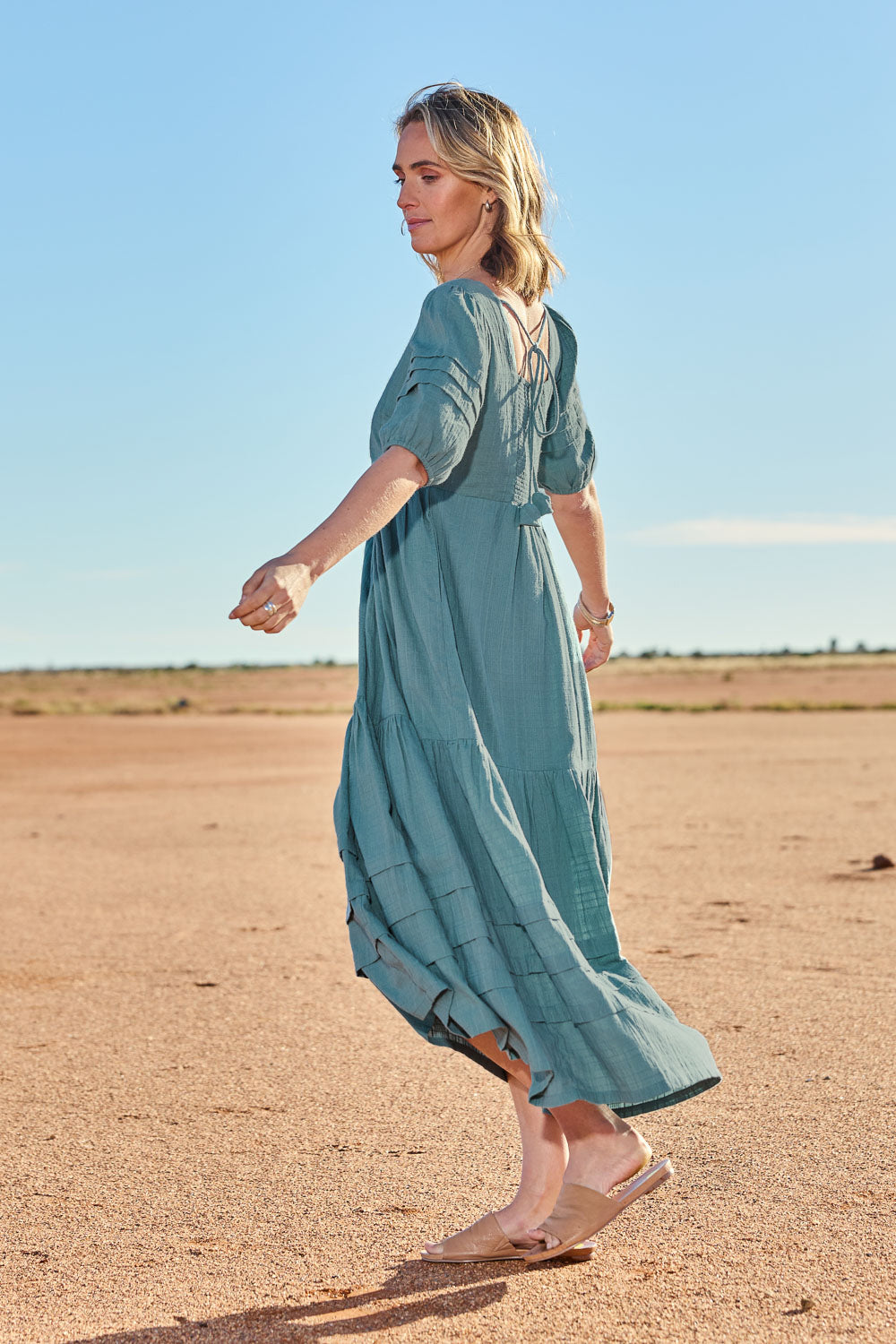 Model Tegan wearing size 10 of the Chasing Butterflies Cotton Dress in colour Sage (Green), from the front, showing the whole outfit