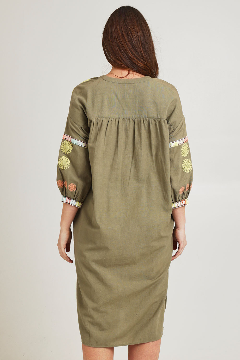 Model Jane wearing size 14 of the Now And Then Embroidered Tunic Dress in colour Khaki, from the back