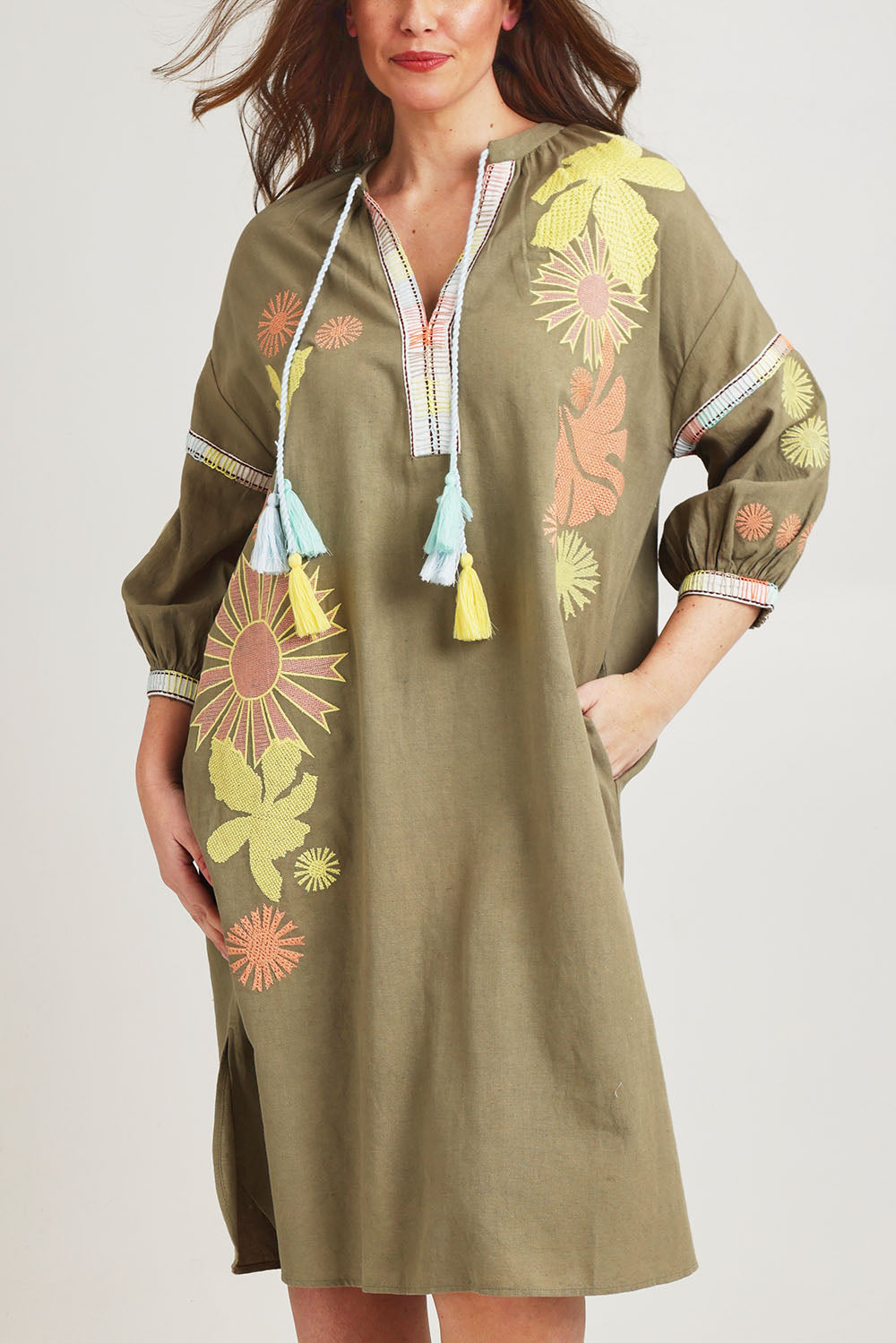 Model Jane wearing size 14 of the Now And Then Embroidered Tunic Dress in colour Khaki, from the front, cropped image