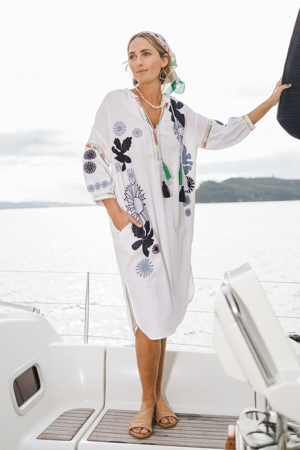Model Brooke wearing size 10 of the Now And Then Embroidered Tunic Dress in colour White (White), from the front, showing the whole outfit