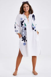 Model Monique wearing size 14 of the Now And Then Embroidered Tunic Dress in colour White (White), from the front, showing the whole outfit