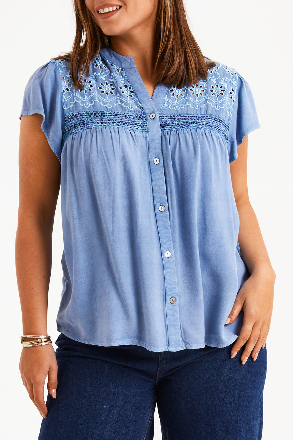 Model Monique wearing size 14 of the Floral Fields Embroidered Top in colour Chambray (Blue), from the front, cropped image