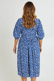 Model Laura wearing size 14 of the In The Morning Light Wrap Dress in colour Blueleaf (Blue), from the back