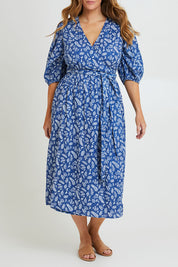 Model Laura wearing size 14 of the In The Morning Light Wrap Dress in colour Blueleaf (Blue), from the front, cropped image