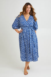 Model Laura wearing size 14 of the In The Morning Light Wrap Dress in colour Blueleaf (Blue), from the front, showing the whole outfit