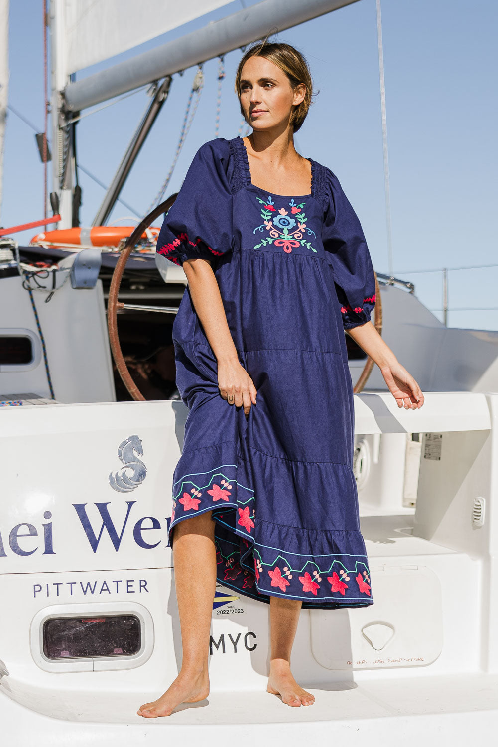 Model Tegan wearing size 10 of the Picnic In The Fields Embroidered Dress in colour Navycombo (Blue), from the front, showing the whole outfit