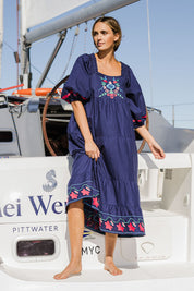 Model Tegan wearing size 10 of the Picnic In The Fields Embroidered Dress in colour Navycombo (Blue), from the front, showing the whole outfit