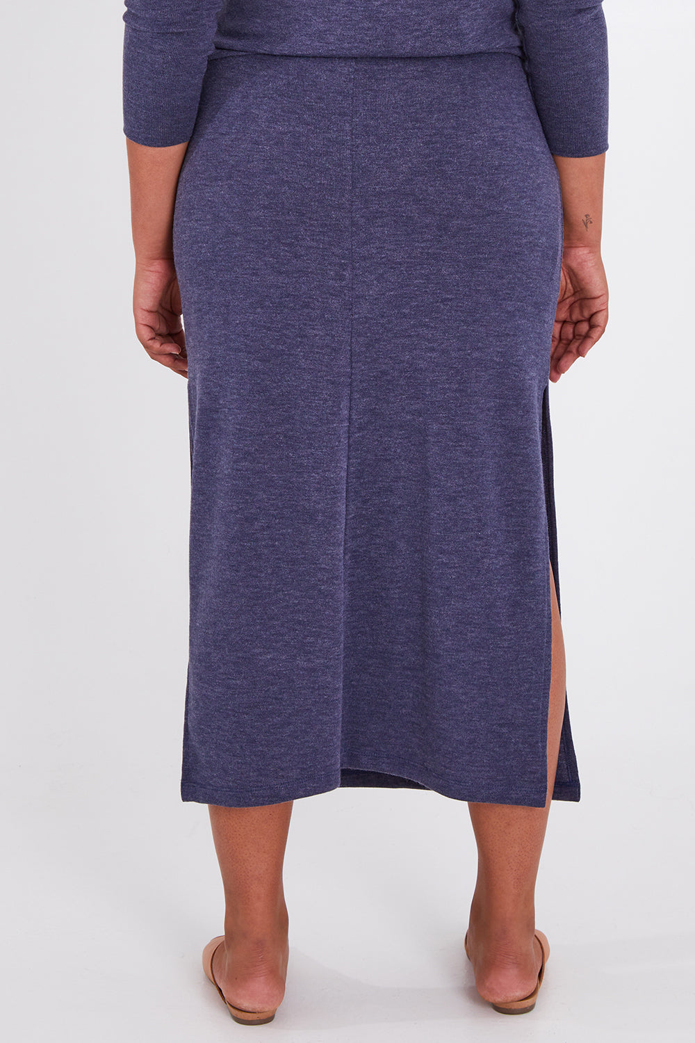 Model Anucia wearing size 14 of the Snuggle Up Maxi Skirt in colour Marldenim (Blue), from the back