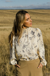 Model Tegan wearing size 10 of the Teatime And Flowers Blouse in colour Cream (White), from the front, showing the whole outfit