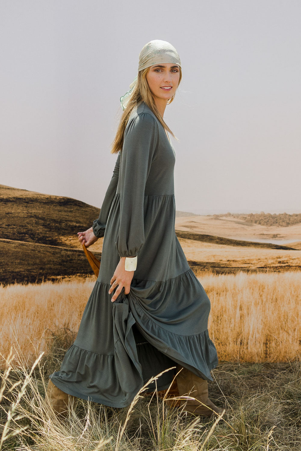 Model Tegan wearing size 10 of the Tiered Delight Bamboo Dress in colour Combat (Green), from the front, showing the whole outfit