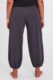 Model Anucia wearing size 14 of the Keeping It Cool Boyfriend Pants in colour Castle (Grey), from the back