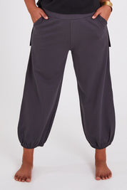 Model Anucia wearing size 14 of the Keeping It Cool Boyfriend Pants in colour Castle (Grey), from the front, cropped image