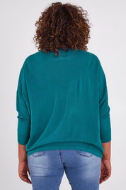 Model Anucia wearing size L of the Chill Vibes Slouch Top in colour Jade (Green), from the back