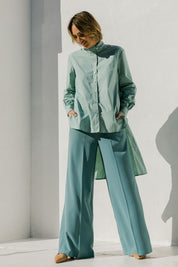Model Tegan wearing size 10 of the Ringmaster Of My Life Shirt in colour Sage (Green), from the front, showing the whole outfit