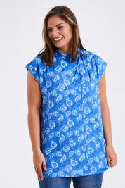 Model Monique wearing size 14 of the Forget Me Not Sleeveless Blouse in colour Bluewhite (Blue), from the front, cropped image